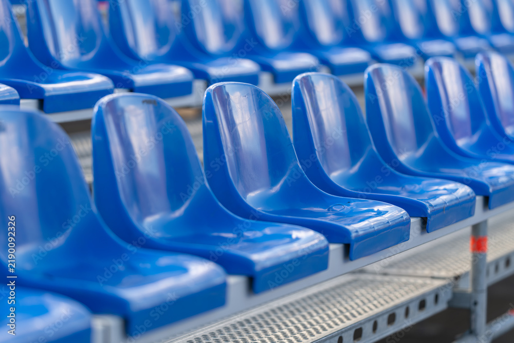 Fototapeta premium Vibrant blue stadium seats arranged in perfect lines inviting crowds for an exciting sporting event