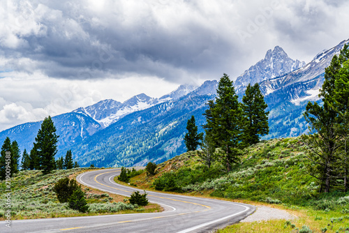 Bild auf Leinwand Mountain Road with a sweeping bend bordered by pale sagebrush