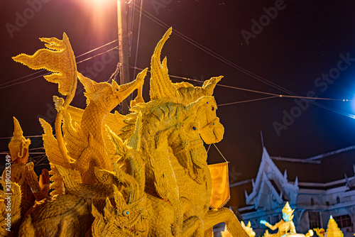 Buddhist Lent tradition, a beautiful display of wisdom, beeswax candles create art as a Buddhist offering.Background with Thai pattern carved on the surface of Lent candle.Ubon Ratchathani.Festival