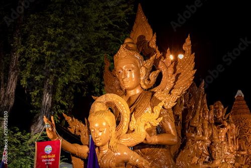 Buddhist Lent tradition, a beautiful display of wisdom, beeswax candles create art as a Buddhist offering.Background with Thai pattern carved on the surface of Lent candle.Ubon Ratchathani.Festival