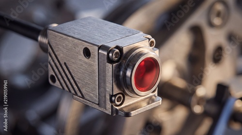 Industrial machine vision camera with red lens, high-tech optical sensor for automated inspection, brushed metal electronic component