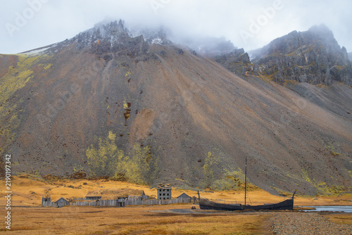 Viking village film set and wooden longship under dramatic Vestrahorn mountain in Stokksnes, Iceland
