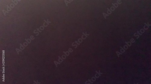 Minimalist abstract video footage featuring a moody, muted dark brown gradient surface with subtle lighting. Ideal for dark mode UI backgrounds and cinematic video overlays.