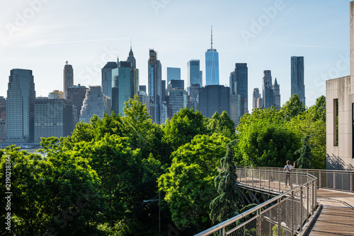 Panoramic view of the Lower Manhattan skyline from Squibb Park Bridge in Brooklyn, with One World Trade Center rising above the Financial District.