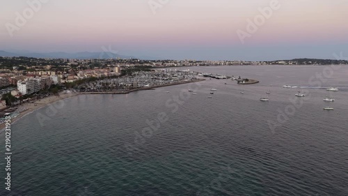 Aerial view of Antibes harbor and coastline at sunset, France.