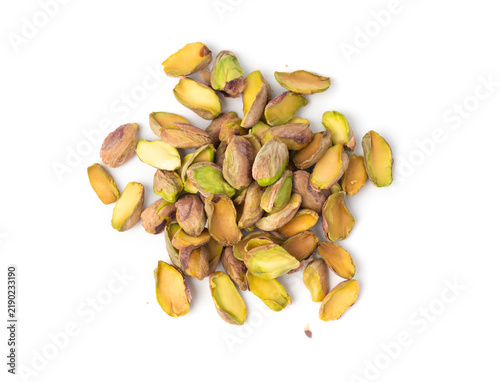 Fried salt pistachio nuts isolated. Baked pistachios pile, roasted green pistache fruits on white