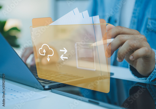 Obraz na plátně Digital folder interface with person using stylus beside laptop and tablet managing cloud documents file transfer secure storage paperless workflow and efficient business data organization