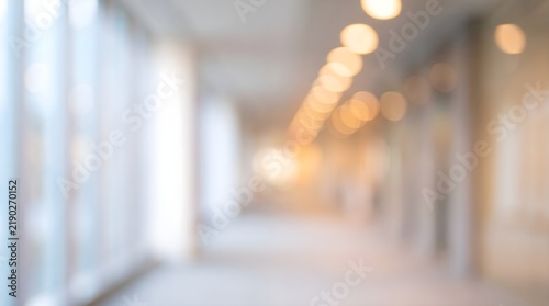 Blurred office hallway background, modern corporate building interior with bokeh lights, bright professional workspace with soft focus