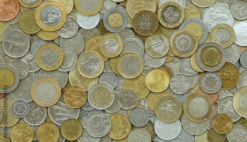Big pile of coins from different money currencies. Treasure and numismatics concept