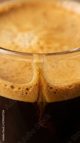 Rich espresso with thick golden brown crema in a glass cup