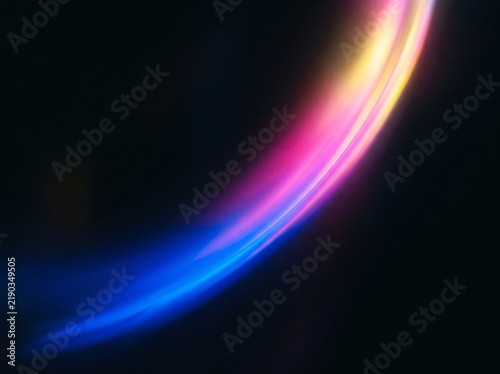 Vibrant colorful light streak curving across dark background with pink and blue hues
