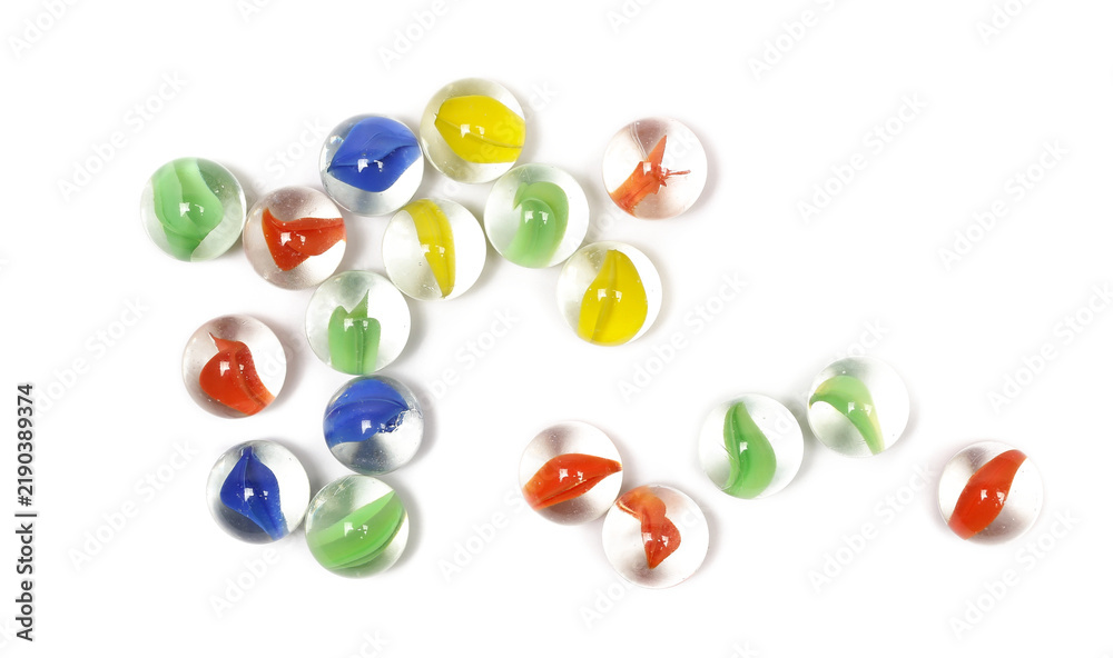 Obraz premium Colorful glass marbles grouped together isolated on white background, top view