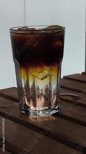 Espresso tonic coffee drink with lemon garnish