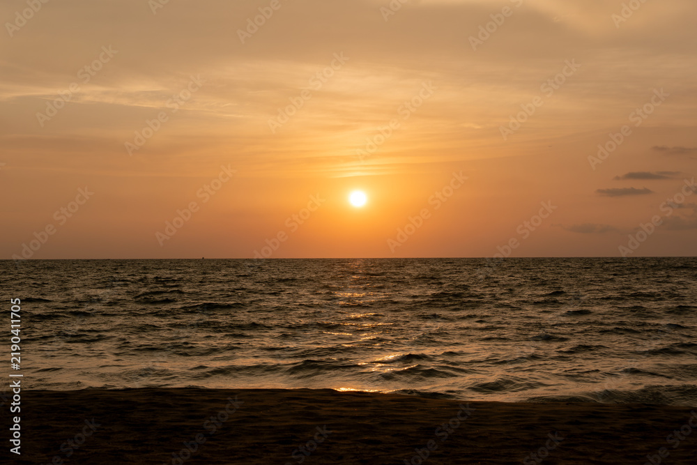 Fototapeta premium harmonic background of scenic sunset with bright sun at the ocean