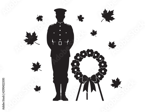 Soldier standing in uniform next to a memorial wreath with falling maple leaves silhouette