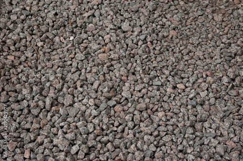 Close-up texture of a surface covered entirely with fine crushed stone.