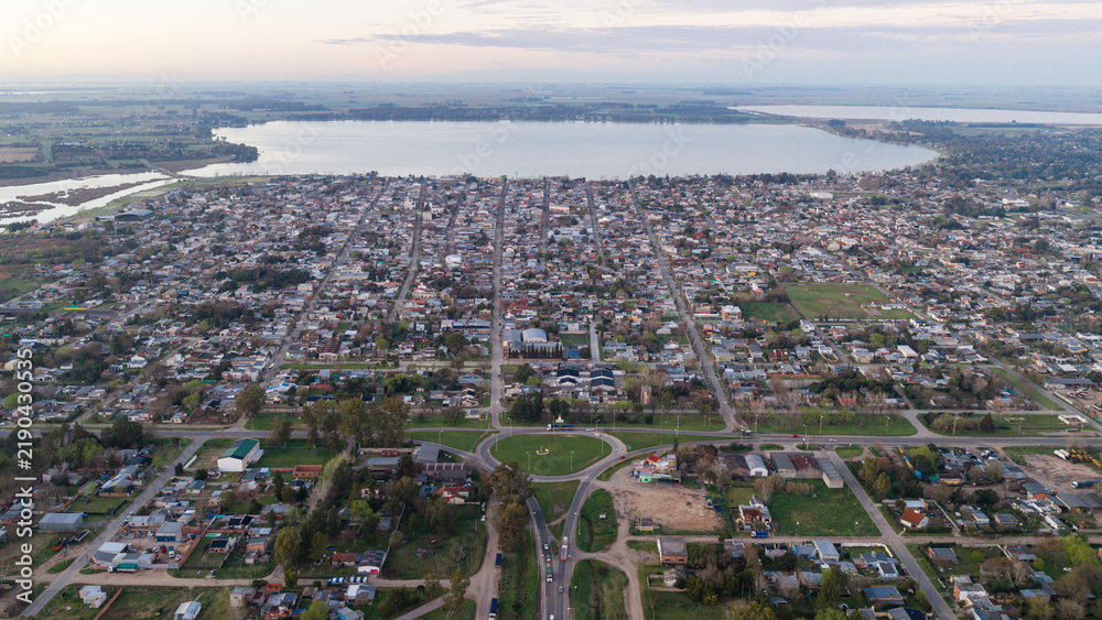 Fototapeta premium Aerial view of San Miguel del Monte and Laguna de Monte at dawn, Argentina.