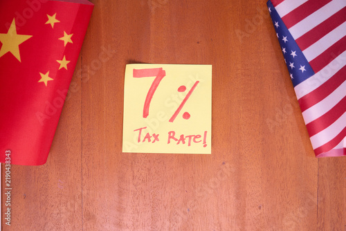 7 percent tax rate note between China and US flags on wooden table for US effective import tariff policy 2026 concept