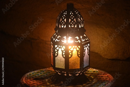 arabian lamp shinning ligh on table in dark night