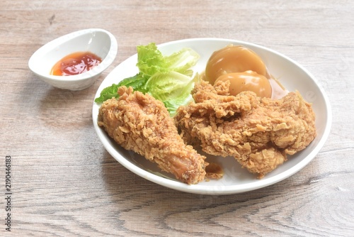 crispy fried chicken and mashed potato dressing gravy sauce with cos lettuce salad on plate dipping ketchup and chili sauce