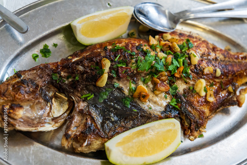 Traditional Canarian seafood dish. A freshly caught and deep-fried whole Vieja (parrotfish), a typical local fish of the Canary Islands