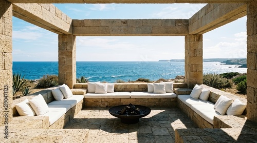 Stone patio lounge overlooking blue ocean horizon.