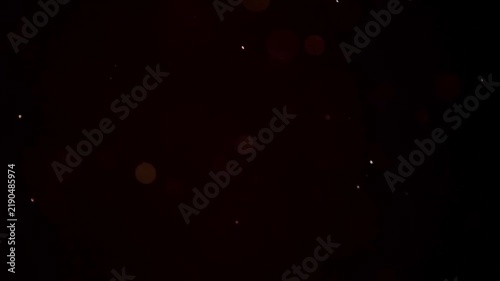 Abstract dark red floating dust particles and bokeh lights