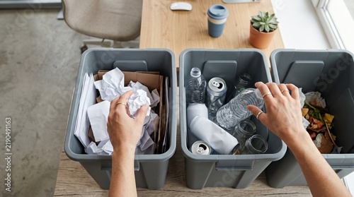 Person sorting waste into three recycling bins for paper plastic and general trash vector illustration
