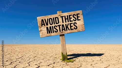Avoid these mistakes signpost standing alone in a vast arid desert landscape under a clear bright deep blue sunny sky