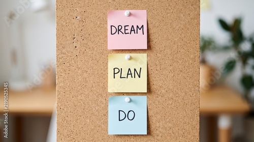Sticky notes with dream plan do text on a cork board