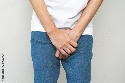 Quadro su tela Closeup annoying itch asian man with an itchy his jock and butt, male scratching crotch with his hand, itching groin, male suffering body problem