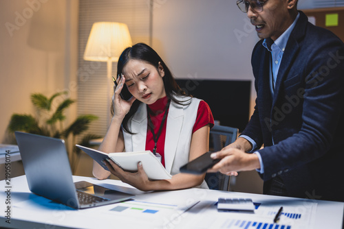 Quadro su tela Employee feeling stressed and anxious during a reprimand from her boss late at night, dealing with workplace conflict and pressure