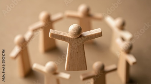 Wooden figurine representing servant leadership concept surrounded by other figurines