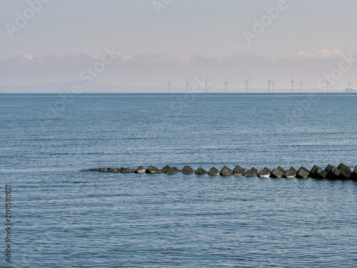 Принти на полотні Calm blue sea with tetrapod blocks and offshore wind turbines Hokkaido
