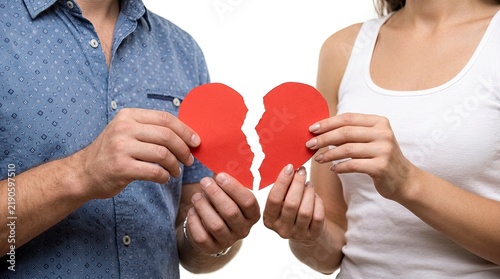 Couple Holding Broken Heart Puzzle Pieces Symbolizing Relationship Breakup.