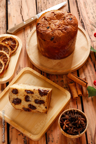 Chocolate panettone served during Christmas festivities on a rustic wooden table with traditional decorations.