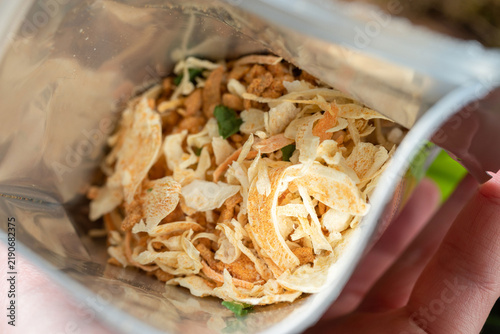 Macro shot of dry freeze-dried soup ingredients inside a open foil zip lock bag. Dehydrated vegetables and spices for outdoor camping meals.
