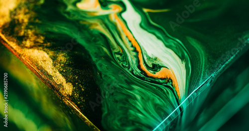 Shiny ink. Acrylic flow. Defocused green yellow neon color mix sparkling texture glitter fluid floating on abstract art background.