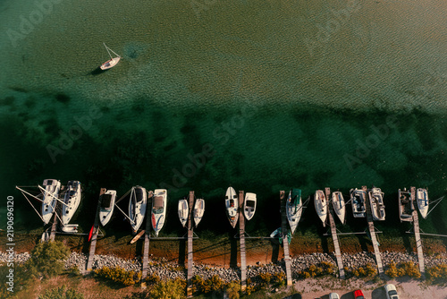 shoreline of a bay with boats from a drone 