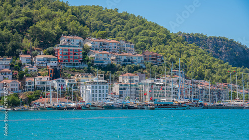 Cuadro en lienzo Sailboats and waterfront buildings line the marina in Fethiye, Turkey, beneath a
