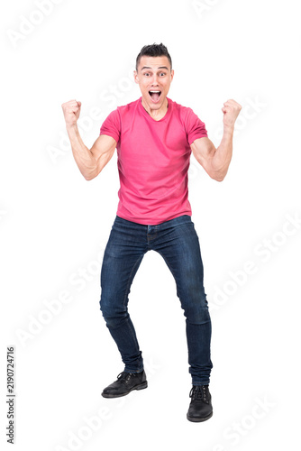 Fotografía Full body happy male in jeans and pink t shirt clenching fists and looking at ca