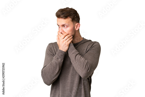 Obraz na plátne Young handsome caucasian man over isolated chroma key background covering mouth