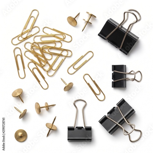 Gold paper clips and black binder clips on white background. Brass thumb tacks and office supplies. Professional stationery set for business.