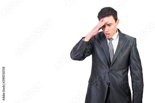 Obraz na płótnie Shocked man in elegant suit looking down with hand on forehead