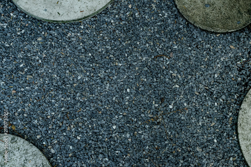 Photography Overhead view of a dark crushed gravel garden pathway framed by curved concrete
