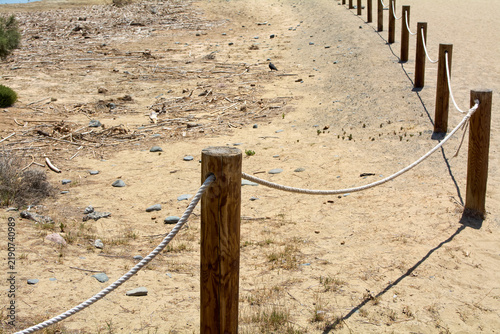 Detail of a protective barrier fence separating the natural reserve area from the public path at Charca de Maspalomas.