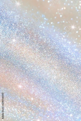 Sparkling silver glitter surface with subtle pastel reflections and bright star-like highlights