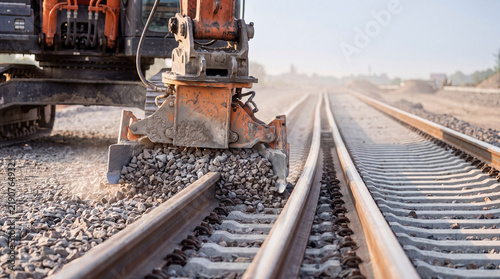 Excavator working on railway tracks