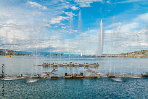 Musical dancing water fountain show in Jardin Anglais with the famous Jet d'Eau landmark in the background on Lake Geneva, scenic summer travel destination in Geneva, Switzerland.