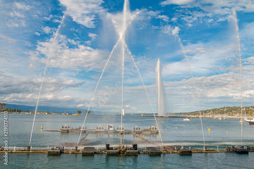 Musical dancing water fountain show in Jardin Anglais with the famous Jet d'Eau landmark in the background on Lake Geneva, scenic summer travel destination in Geneva, Switzerland.
